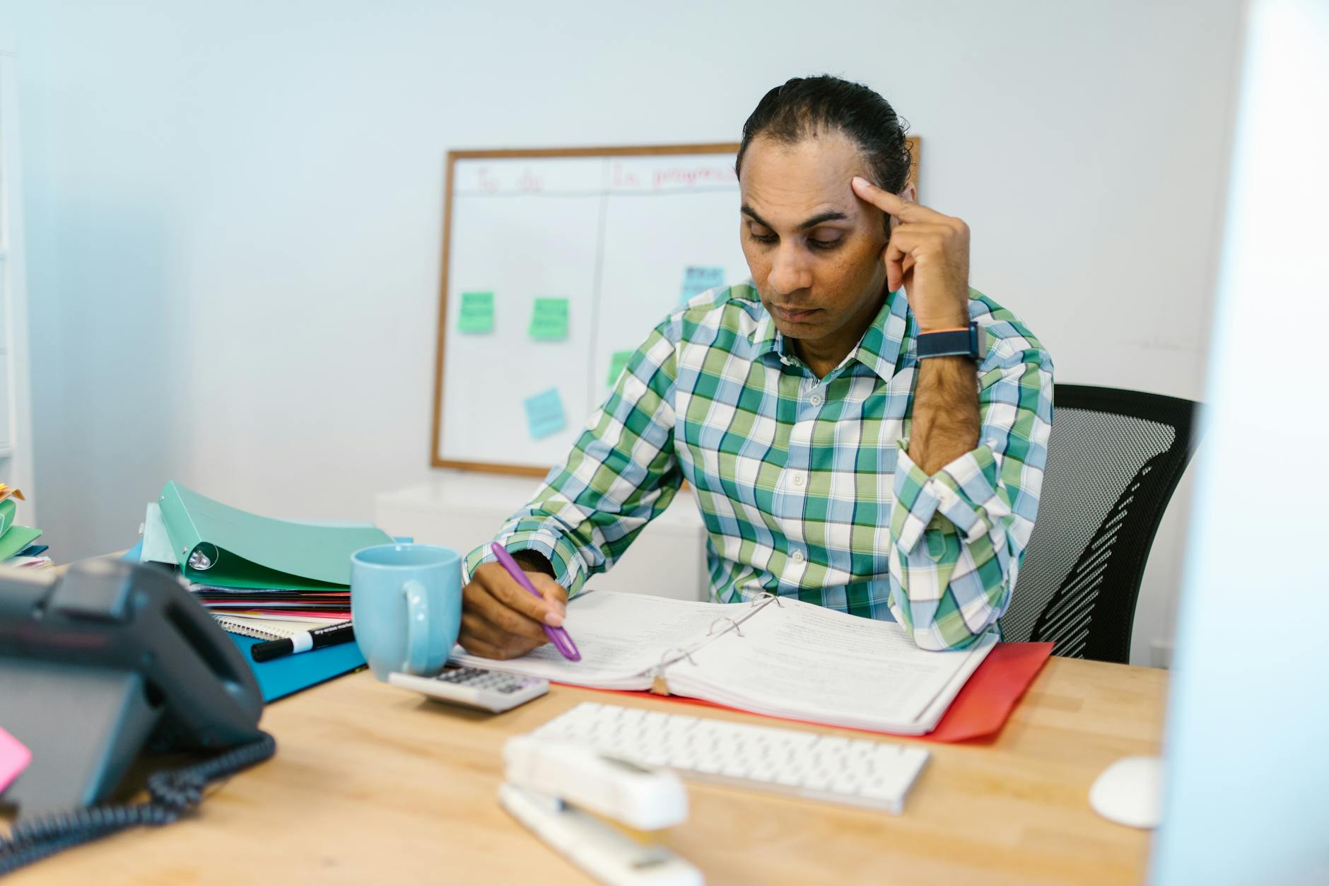 A man researching on a laptop at a desk